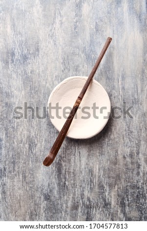 Chashaku Matcha spoon and empty ceramics plate on rustic wooden background. Symbolic image. Asian culture. Top view. Copy space.