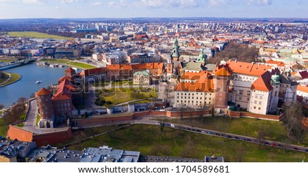 View from above of fortified architectural complex of Wawel Сastle and Archcathedral Basilica on banks of Vistula river in springtime, Krakow, Poland

