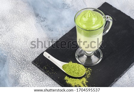 Dalgona Matcha Latte, a creamy whipped matcha, on light background. Matcha green tea.