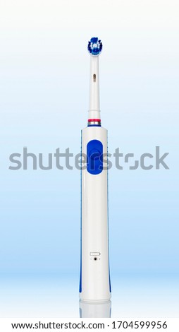 Electric toothbrush on white blue background
