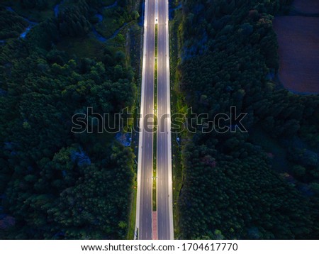 Aerial night view of suburban empty roads with streetlights during lockdown 