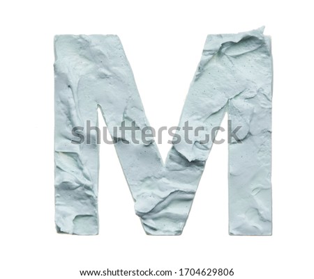 Stencil letter M made by using a cosmetic product on a white background.