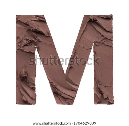 Stencil letter M made by using a cosmetic product on a white background.