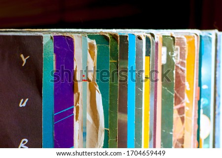 Stack of old vinyl records, close-up. Vinyl albums and records in a music store, vintage process. Retro styled image of boxes with vinyl record players.
