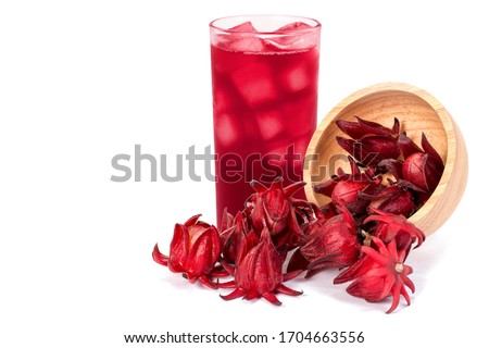Fresh Roselle fruit ( Jamaica sorrel, Rozelle or hibiscus sabdariffa ) in wooden bowl and glass of roselle juice tea isolated on white background.  Royalty-Free Stock Photo #1704663556