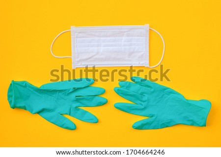 Surgical protective mask and medical gloves on the Yellow background. Healthcare medical Coronavirus quarantine, Concept Of Air pollution or allergy, flat lay banner, top view, copy space