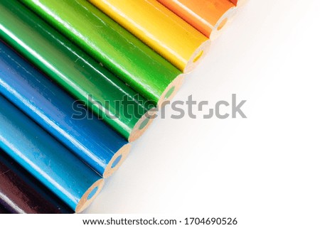 assorted colored pencils used for drawing and coloring on a white background