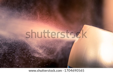 aerosol can sprays air freshener scent into a room Royalty-Free Stock Photo #1704690565
