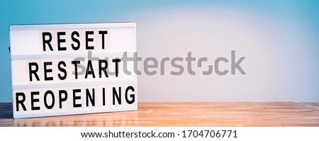 Words reset, restart and reopening on the light box. New life, new business, new deals concept. Royalty-Free Stock Photo #1704706771