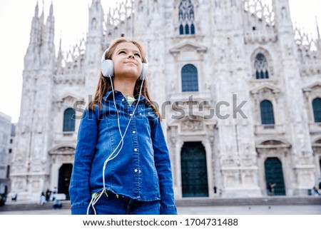 Beautiful child enjoy her holiday in front of Duomo Milan