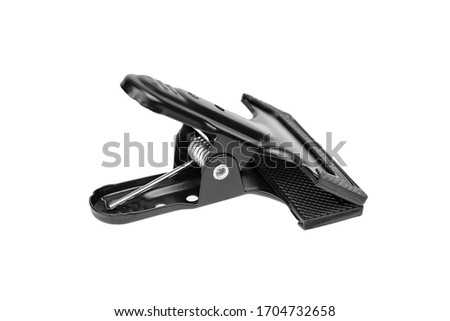 Clamp, spring clip for attaching background. Metal case with rubber protective sleeve, isolated on white background