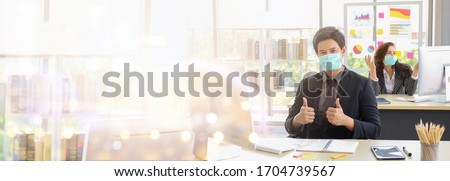 Banner image of Business people wear mask while working in office with copy space