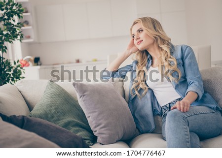 Photo of domestic pretty charming blond lady relaxing sit comfy couch staying home good mood lean head on hand dreamer quarantine time lighted living room indoors