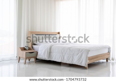 Wooden bed, white mattress, white curtain Royalty-Free Stock Photo #1704793732