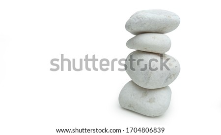 White stones balanced in tower, isolated on white. Minimalist ornament signifying simplicity.