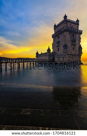 photo of the sunset in the belem tower with the golden sky