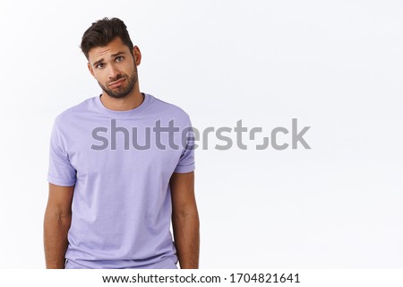 Cute and silly charming boyfriend looking gloomy at girlfriend complaining tough day, sulking and gazing with condole or compassion, feeling empathy person having bad day, standing white background Royalty-Free Stock Photo #1704821641