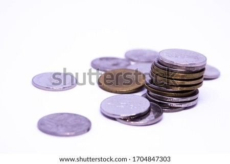 Thai coins are stacked in different positions on a white background.