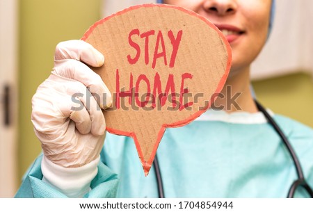 doctor woman holding  carton card  with stay home. Novel coronavirus - 2019-nCoV concept