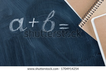 Notebook on a blackboard with the inscription. Education concept.
