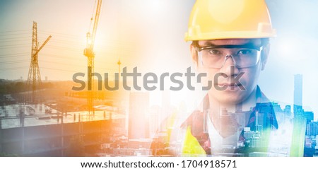 The double exposure image of the engineer holding a blueprints standing building site overlay with cityscape in sunrise.The concept of construction,smart city,engineering,architecture and future.