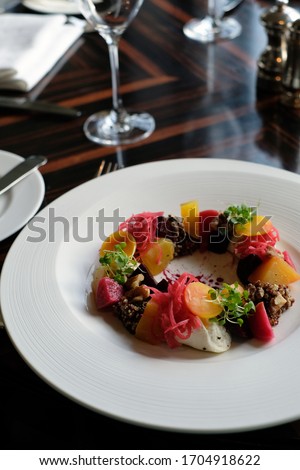 Vegeratian dish featuring carrots and beetroot is served in Michelin starred restaurant Royalty-Free Stock Photo #1704918622