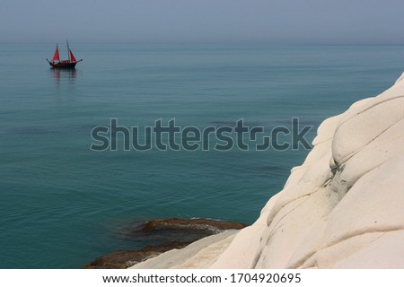 Pirates of the Mediterranean. Small sailboat near the Scala dei Turcchi (Agrigento) in Sicily.