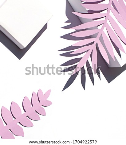 Tropical leaves shadows on the white paper background on the noon sun. Summer concept frame.
