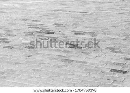 Top view on monochrome paving stone road. Old pavement of granite texture. Street cobblestone sidewalk. Abstract background for design.