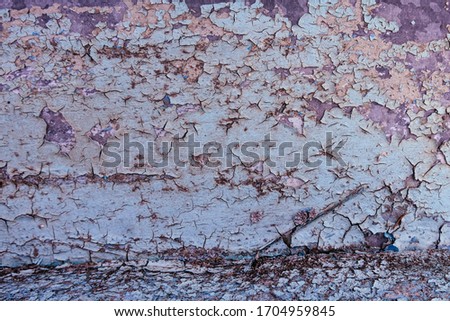 Background. A fragment of the iron surface is covered with old turquoise paint that has long been on it