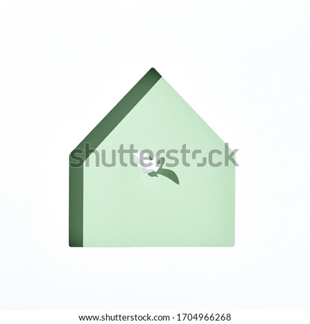 Minimal creative layout with white dove and green house shape. Stay home, stay safe 2020 concept. Top view, flat lay. 
