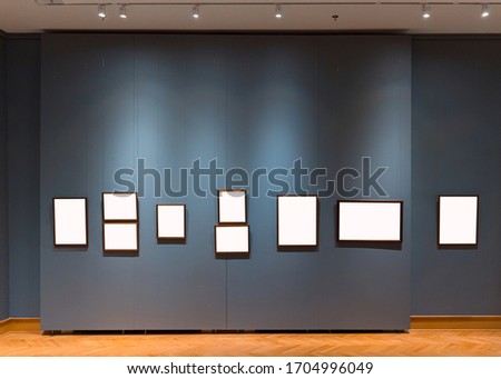 Museum wall full of hanging empty wooden frame for exibition