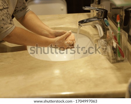 
washing hands with soap in the bathroom