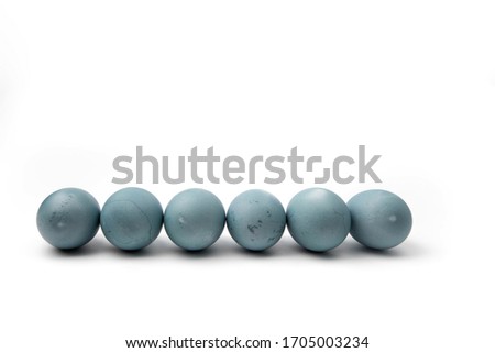a row of blue chicken eggs colored with natural dye