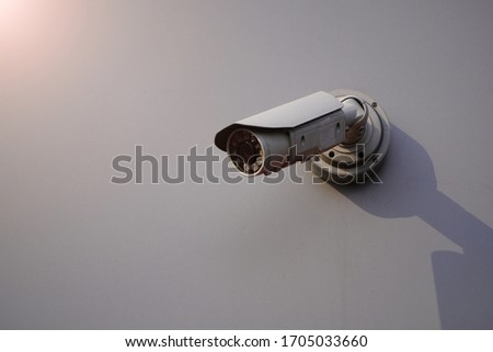 Camera CCTV on the facade of a modern office building on the street, security in the city. Covert shooting of what is happening. Modern technologies and equipment Royalty-Free Stock Photo #1705033660
