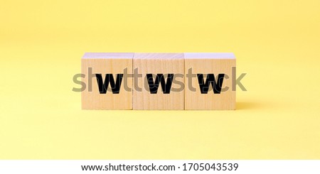 WWW inscription on wooden block isolated on yellow background online communication concept