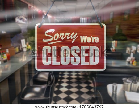 A business sign that says ‘Sorry, We're Closed’ on cafe/restaurant window.
