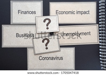On kraft paper shows the impact of COVID-19 Coronavirus on business, economic crisis, finance. Coronavirus concept on black background.                               