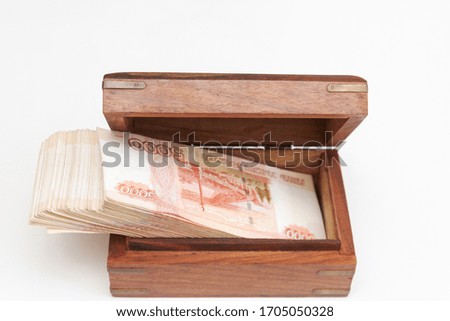 Russian banknotes of five thousand rubles in large quantities in a wooden box