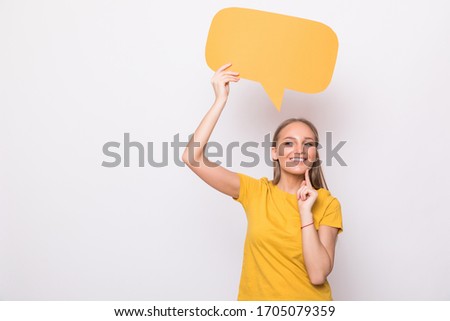 Young beautiful girl holding a orange bubble for text, on a white background