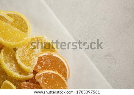 Jelly candy's. Dessert marmalade, lemon and orange slices. The sweetness of jelly candy yellow and orange. Marmalade isolated on grey background.
