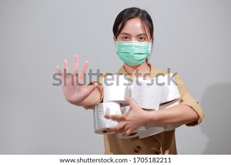Asian woman hoarding tissue toilet paper during Coronavirus outbreak or Covid-19, Concept of Covid-19 Dangerous virus, Doomsday panic people panic.