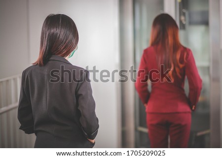 Two woman Asian people standing distance of 1 meter from other people keep distance protect from COVID-19 viruses and people social distancing for infection risk. Royalty-Free Stock Photo #1705209025