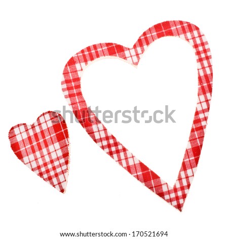 two figures in the shape of heart of checkered fabric in red cell isolated on white background