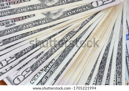 Fan of many one hundred and fifty dollar bills on wooden background surface close up. Flat lay top view. Abstract business concept