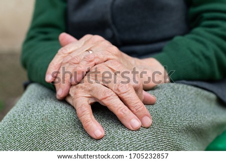 Close up picture of elderly hands of a widowed woman