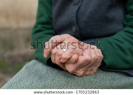 Close up picture of elderly hands of a widowed woman