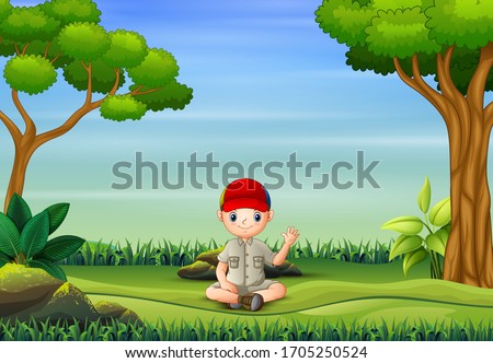 The scout boy sitting and waving in nature background