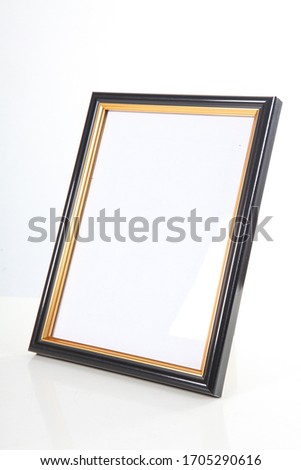 beautiful photo frame in black with a bronze border on a white background
