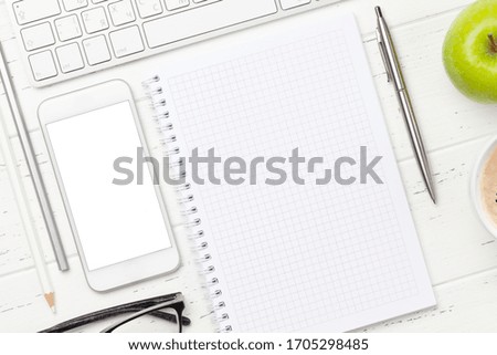 Office workplace desk table with computer, smartphone, notepad and coffee. Top view with space for your text or app. Flat lay